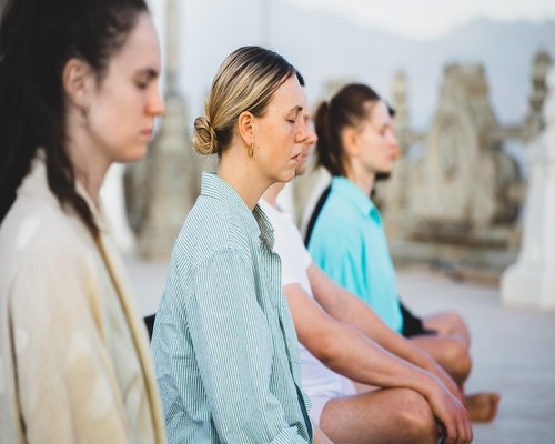 Group of people doing yoga meditation